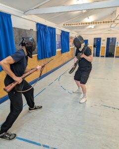 Two students facing off with rifles practicing bayonet techniques