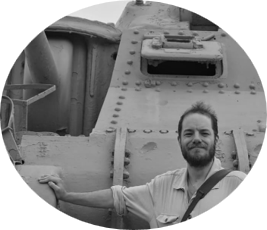 A Picture of an instructor of Battalion Martial Arts James smiling at the camera in front of an M3 Lee Tank